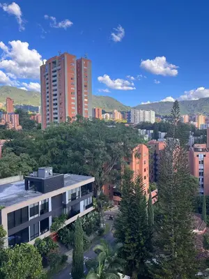a view of a city with tall buildings and trees at El Poblado acomodación familiar hasta 6 personas in Medellín