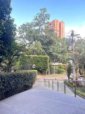 a walkway in a park with a fence and trees at Poblado 1 hasta 4 personas in Medellín