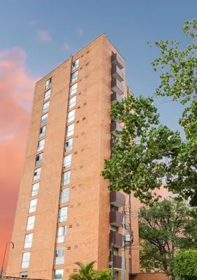 a tall brick building with windows on the side of it at Poblado 1 hasta 4 personas in Medellín