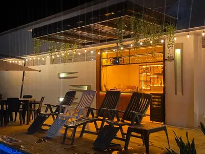 a group of chairs sitting in front of a restaurant at Hotel Bella Isa in La Dorada