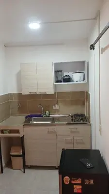 a small kitchen with a sink and a stove at Apartaestudio Rionegro cerca Aeropuerto in Rionegro