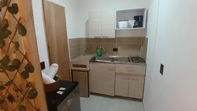 a small kitchen with a sink and a stove at Apartaestudio Rionegro cerca Aeropuerto in Rionegro