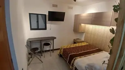 a small bedroom with a bed and a fireplace at Apartaestudio Rionegro cerca Aeropuerto in Rionegro