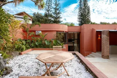 a small backyard with a table and a house at Casa Penta Top Notch Villa in Medellín