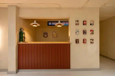a lobby with a red counter with pictures on the wall at Casa Penta Top Notch Villa in Medellín