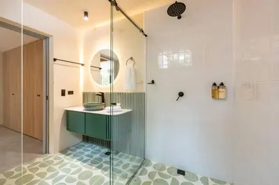 a bathroom with a sink and a glass shower at Casa Penta Top Notch Villa in Medellín