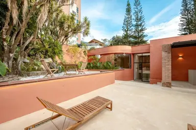 a patio with a chair and a house at Casa Penta Top Notch Villa in Medellín