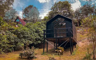 a out house sitting in the middle of a field at Tiny House La Silleta in Medellín
