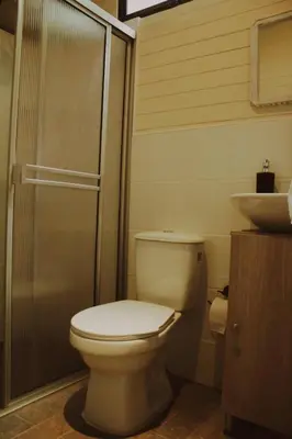 a bathroom with a toilet and a sink at Tiny House La Silleta in Medellín