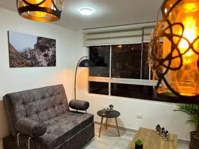 a living room with a couch and a window at Lindo y disponible Apartamento camino a termales in Manizales
