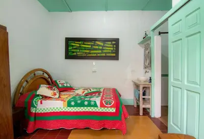 a bedroom with a bed and a picture on the wall at CASA DUQUE JARDIN in Jardin