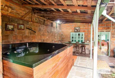 a large room with a tub in a brick wall at CASA DUQUE JARDIN in Jardin