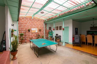 a ping pong table in a room with a brick wall at CASA DUQUE JARDIN in Jardin