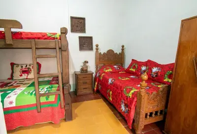 a bedroom with two beds and a bunk bed at CASA DUQUE JARDIN in Jardin