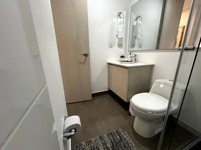 a small bathroom with a toilet and a sink at Apartamento frente a Mallplaza in Manizales