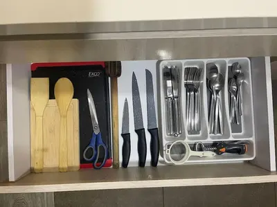 a drawer full of kitchen utensils on a shelf at Apartamento frente a Mallplaza in Manizales