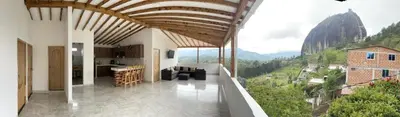 a living room with a view of a mountain at Cómoda casa con espectacular vista a la piedra y embalse in Guatapé