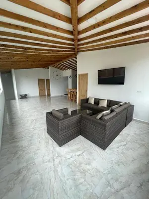 a large living room with couches and a flat screen tv at Cómoda casa con espectacular vista a la piedra y embalse in Guatapé
