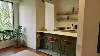 a kitchen with a counter with stools in it at Seijakumanila in Medellín