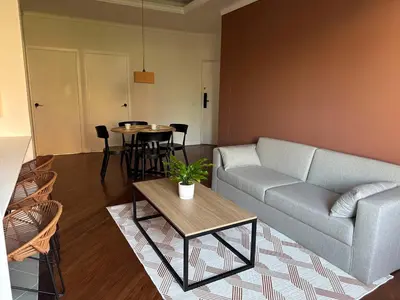 a living room with a couch and a table at Seijakumanila in Medellín