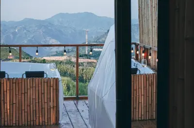 a balcony with a table and a view of the mountains at Hotel Villa Del Sol in Marquetalia