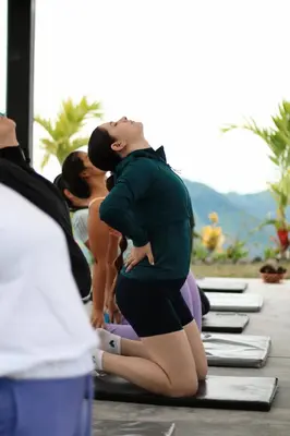 a pregnant woman sitting on a group of yoga mats at Hotel Villa Del Sol in Marquetalia