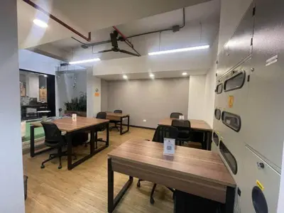 an office with tables and chairs in a room at Apartamentos en el Poblado Medellín - Be Together by Roots Rentals TOG APTOS in Medellín