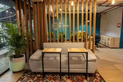 a living room with a couch and two tables at Apartamentos en el Poblado Medellín - Be Together by Roots Rentals TOG APTOS in Medellín