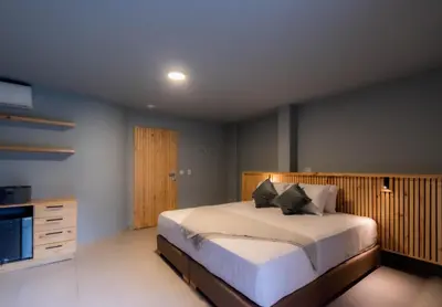 a bedroom with a large bed and a television at Leviu by Bernalo Hotels in Medellín