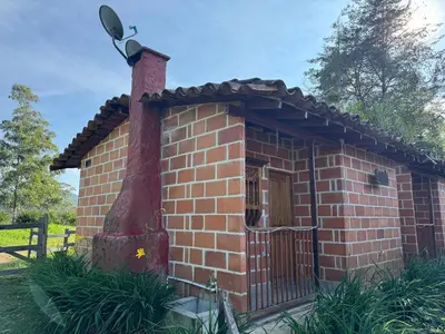 a small brick building with a camera on top at Hotel Campestre - CIUDADELA EL ARTESANO in Carolina del Principe