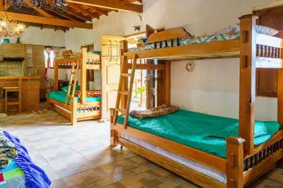 a room with three bunk beds in a house at Hotel Campestre - CIUDADELA EL ARTESANO in Carolina del Principe