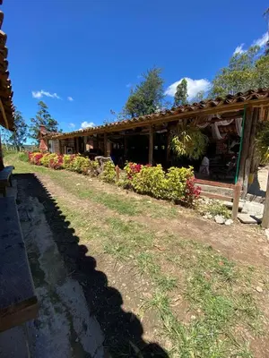 a building with flowers in front of it at Hotel Campestre - CIUDADELA EL ARTESANO in Carolina del Principe