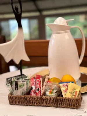 a basket of food and a jug on a table at El Refugio del Colibrí in Santa Rosa de Cabal