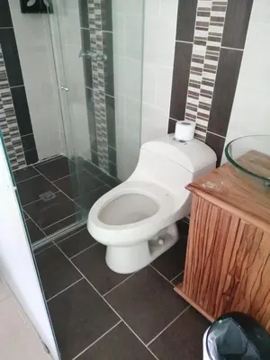 a bathroom with a toilet and a glass shower at The Best Corner in San Rafael