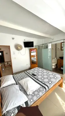 a large bed in a room with a tv on the wall at The Best Corner in San Rafael