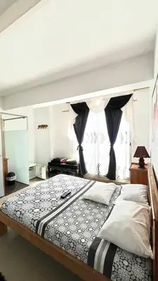 a bedroom with a large bed with a window at The Best Corner in San Rafael