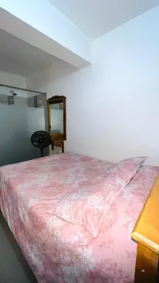 a bedroom with a bed with a pink blanket at The Best Corner in San Rafael