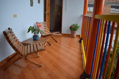 two chairs and a table in a hallway at Hotel Casita de Belén in Sonsón