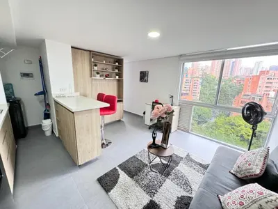 a kitchen and living room with a large window at 1705 Beautiful apartament, total view of the city in Medellín