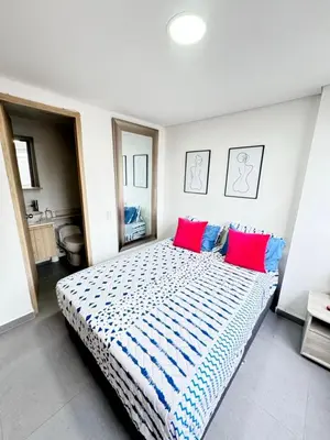 a bedroom with a large bed with red and blue pillows at 1705 Beautiful apartament, total view of the city in Medellín