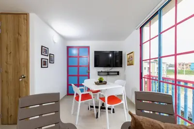 a room with a table and chairs and a tv at Full Apartamento Privado 202 Guatapé in Guatapé