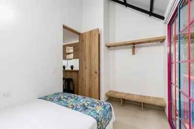 a bedroom with a bed and a window at Full Apartamento Privado 202 Guatapé in Guatapé