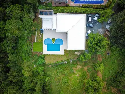 an overhead view of a white building with a cloud at Finca Luz de Luna in Santa Fe de Antioquia