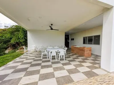 a patio with a table and chairs on a checkered floor at Finca Luz de Luna in Santa Fe de Antioquia