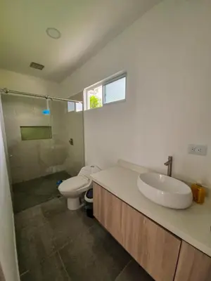 a bathroom with a sink and a toilet and a shower at Finca Luz de Luna in Santa Fe de Antioquia