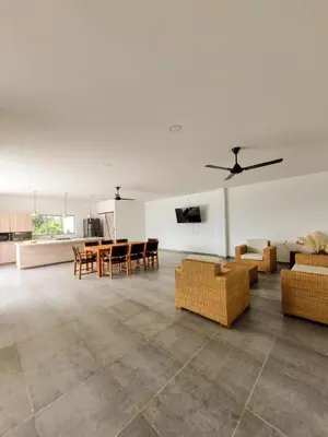 a living room with couches and a table and chairs at Finca Luz de Luna in Santa Fe de Antioquia