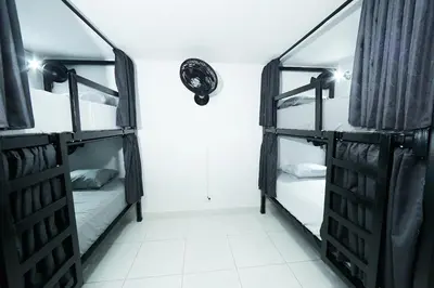 a room with two bunk beds in a dorm at Hostal Casa Host 72 in Medellín