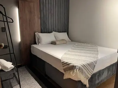 a bed with white pillows and a blanket on it at POBLADO PARK MANILA in Medellín