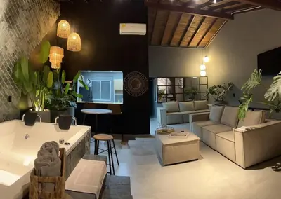 a living room with a tub and a couch and a table at POBLADO PARK MANILA in Medellín