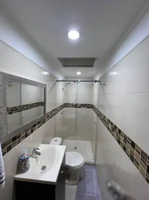 a white bathroom with a sink and a toilet at POBLADO PARK MANILA in Medellín